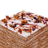 Delicious square honey cake decorated with walnuts and caramel drizzle photo