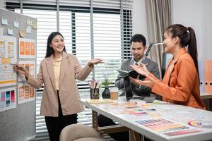 Creative Team Collaborates on UX UI Design in Modern Office Setting with Mood Boards and Digital Devices photo