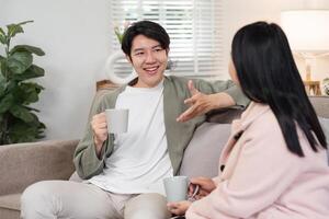 Mother and Son Enjoying Quality Time Together in a Cozy Living Room Setting with Warm Beverages and Relaxed Conversation photo