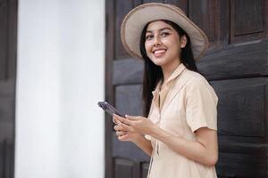 Young Woman Using Smartphone to Navigate City Walking Route, Smiling and Exploring Urban Environment photo