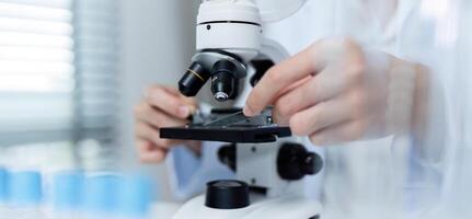 Researchers Analyzing Substance Under Microscope in Modern Laboratory Setting for Scientific Study and Discovery photo