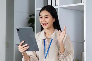 Young Accountant Holding Tablet Communicating with Clients in Modern Office Setting, Professional Business Interaction, Remote Work Concept photo