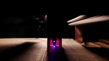 The process of laser wood cutting. A laser machine precisely carves lines on the surface, creating detailed and accurate designs. Perfect for themes of high-tech and manufacturing photo