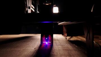 The process of laser wood cutting. A laser machine precisely carves lines on the surface, creating detailed and accurate designs. Perfect for themes of high-tech and manufacturing photo