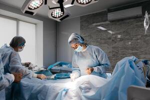 Surgeons performing a delicate operation in a modern operating room, surrounded by advanced medical equipment. The photo captures a moment of precision and expertise in a high-tech environment