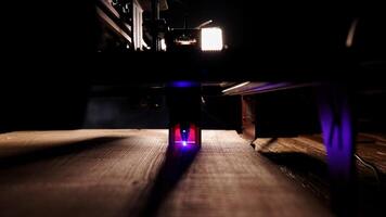 The process of laser wood cutting. A laser machine precisely carves lines on the surface, creating detailed and accurate designs. Perfect for themes of high-tech and manufacturing photo