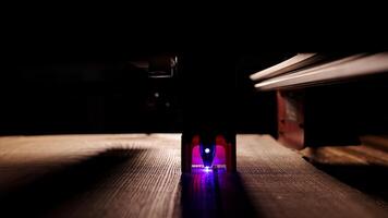 The process of laser wood cutting. A laser machine precisely carves lines on the surface, creating detailed and accurate designs. Perfect for themes of high-tech and manufacturing photo