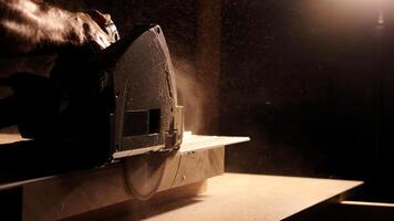 Carpenter using circular saw for cutting wooden plank. Man worker building wooden frame. Carpentry tools in use. Cutting a piece of wood in furniture factory. photo