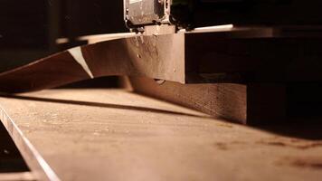 Carpenter using circular saw for cutting wooden plank. Man worker building wooden frame. Carpentry tools in use. Cutting a piece of wood in furniture factory. photo