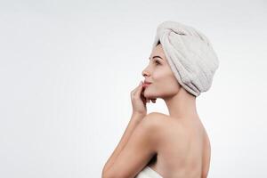 A portrait of a young woman with flawless, smooth skin against a white background. This image embodies allure and femininity, highlighting the concepts of natural beauty and skincare photo