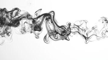 Dark, curling tendrils of smoke gently ascend and swirl, creating an ethereal contrast against the bright white background. The soft textures and fading grays enhance the visual effect. photo