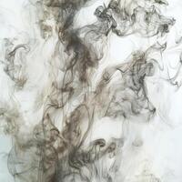 Gentle tendrils of gray smoke ascend from below, creating an ethereal display against a white background. The soft hues and intricate shapes evoke a sense of calm and contemplation. photo