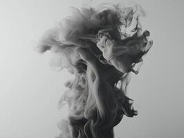 captivating display of gray smoke gracefully ascends, forming intricate, swirling patterns that fade into lighter shades, creating a tranquil yet dynamic visual experience. photo