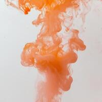 scene features mesmerizing wisps of orange smoke ascending gracefully, merging rich shades of orange with a gentle transparency that creates an artistic allure. photo