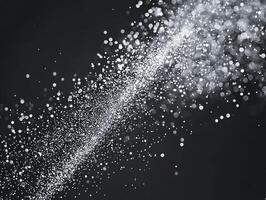 A dynamic scattering of silver particles creates a captivating cosmic effect against a deep black background, reminiscent of twinkling stardust in the universe, alive with energy. photo