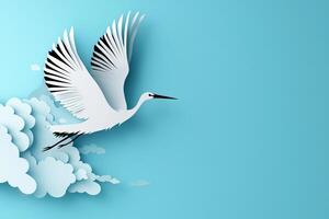 dynamic stork soars through a clear blue sky, its black and white layered paper wings spread wide. The sunlight accentuates its elegant form, creating a minimalist art piece. photo