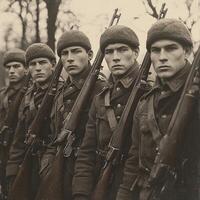 group of five soldiers stands in formation each holding a rifle showcasing their uniforms and serious expressions amid a wooded backdrop during World War I. photo