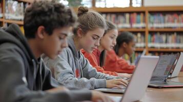 group of students is focused on collaborating for their project utilizing laptops in a well lit school library filled with books. The atmosphere is productive and engaging. photo