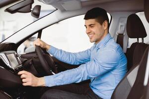 Transportation And Modern Technology Concept. Smiling man checking navigation system on car dashboard screen photo