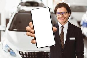 Salesperson In Specs Showing Auto Key To Camera Standing In Automobile Rental Office. Copyspace, Selective Focus photo
