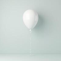 white balloon with string isolated on pastel blue background photo