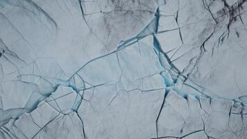 top view of cracks in lake ice with texture as background. photo