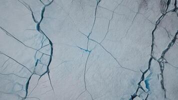 top view of cracks in lake ice with texture as background. photo