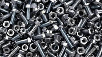 top view of nuts and bolts with texture as background photo