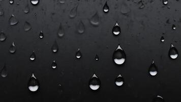 water droplets slid across the black wet surface. photo