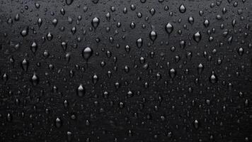 water droplets slid across the black wet surface. photo