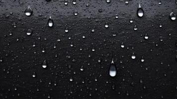 water droplets slid across the black wet surface. photo