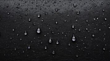 water droplets slid across the black wet surface. photo