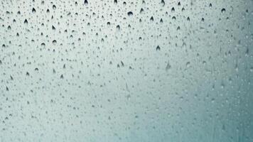 Water droplets slide across the glass surface. photo