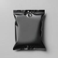 Blank black sachet package isolated on white. Small packaging sachet mockup. photo