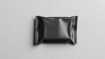 Blank black sachet package isolated on white. Small packaging sachet mockup. photo