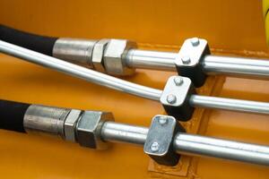 Close-up of an assembly with hydraulic pipes and couplings on a truck photo