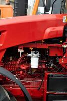 Close-up of part of the new red tractor. Vehicle assembly photo