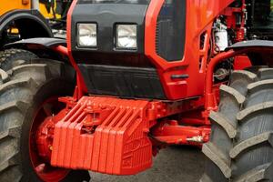 Close-up of part of the new red tractor. Vehicle assembly photo