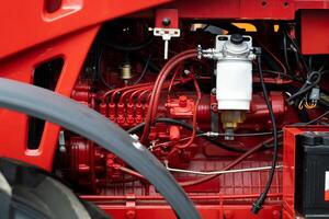 Close-up of part of the new red tractor. Vehicle assembly photo