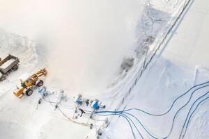 Top view of the work of four snow cannons for the production of artificial snow photo