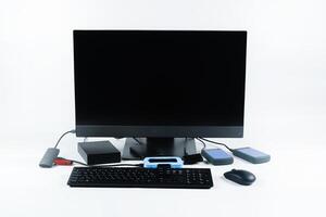 Multiple external hard drives connected to a monoblock on a white background.Computer with hard drive photo