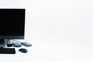Multiple external hard drives connected to a monoblock on a white background.Computer with hard drive photo