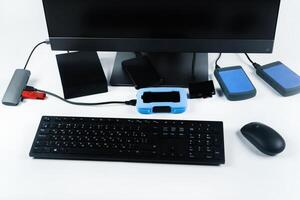 Multiple external hard drives connected to a monoblock on a white background.Computer with hard drive photo