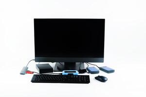 Multiple external hard drives connected to a monoblock on a white background.Computer with hard drive photo