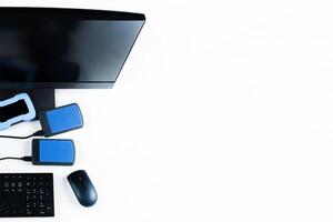 Multiple external hard drives connected to a monoblock on a white background.Computer with hard drive photo