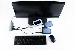 Multiple external hard drives connected to a monoblock on a white background.Computer with hard drive photo