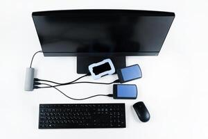 Multiple external hard drives connected to a monoblock on a white background.Computer with hard drive photo