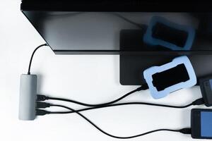 Adapter with connection of external hard drives connected to a monoblock on a white background.Computer with a hard disk photo