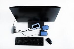 Multiple external hard drives connected to a monoblock on a white background.Computer with hard drive photo