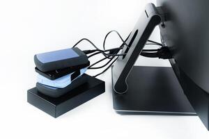Multiple external hard drives connected to a monoblock on a white background.Computer with hard drive photo